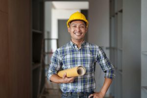 architect man working with blueprints for architectural plan engineer sketching a construction